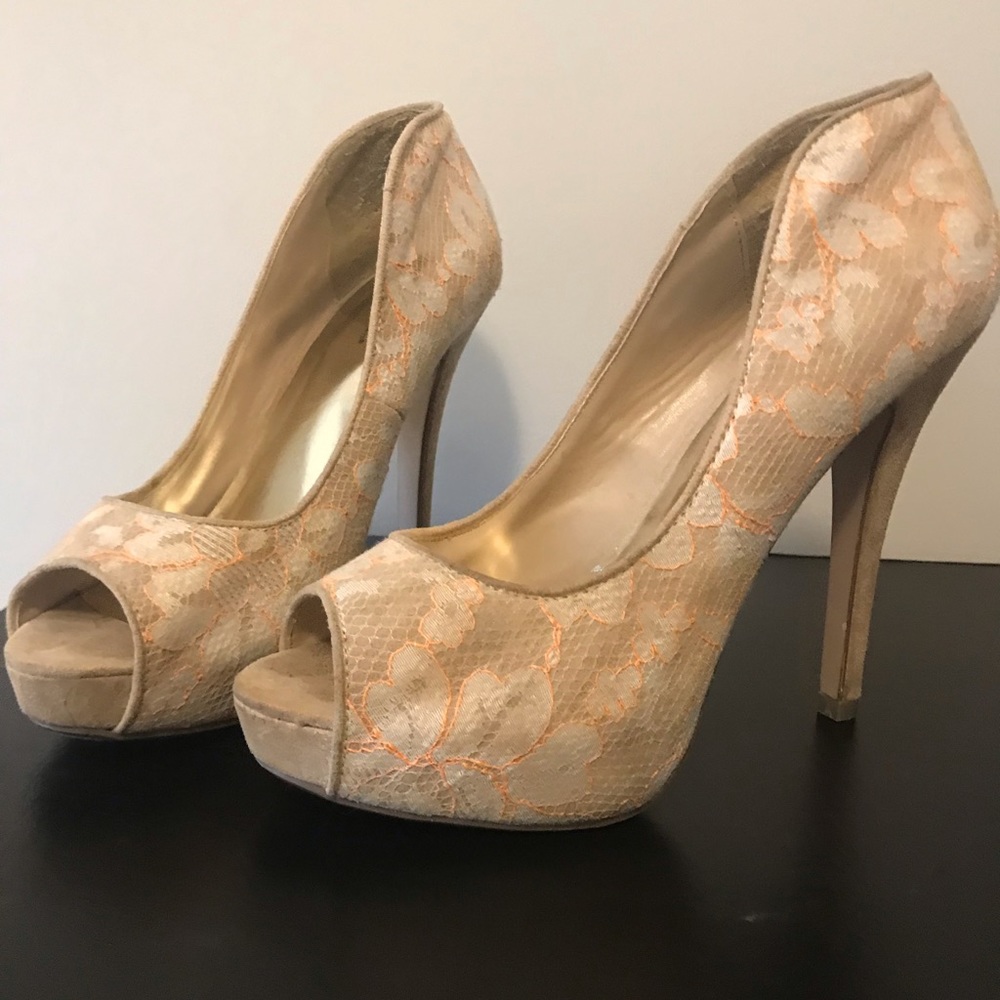 Cream colored pumps with orange piping and lace
